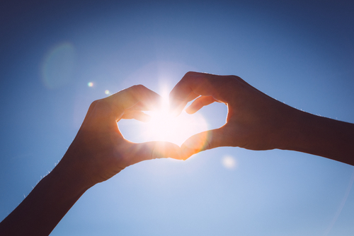 Hands,Making,Love,Shape,Sign,On,Bright,Blue,Sky.